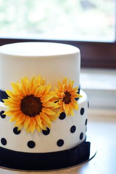 a polka dot cake with sunflowers on top