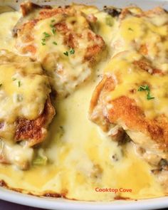 chicken parmesan casserole in a white dish with cheese and herbs on top