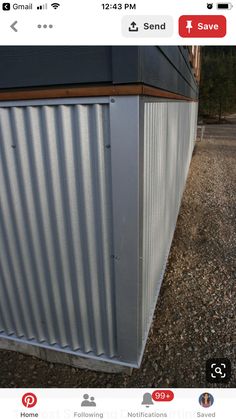 a metal building sitting on top of a gravel field