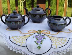 three teapots are sitting on a table