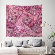 a pink wall hanging over a couch in a living room