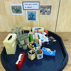 an assortment of crafting supplies on a table with a sign that says can you make a robot?