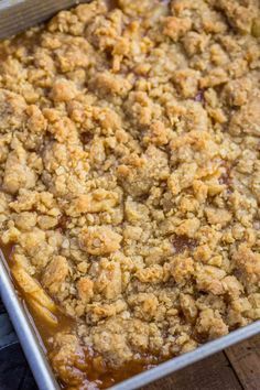 a casserole dish with apples and crumbled toppings in a pan