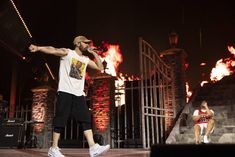 a man standing on top of a stage holding a microphone