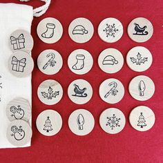 several buttons with different designs on them sitting next to a drawstring bag filled with christmas items