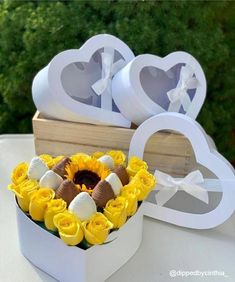 sunflowers and chocolate in a heart shaped box with the word love on it