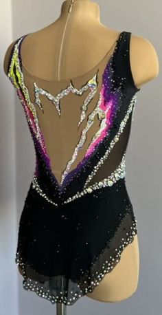 a mannequin wearing a black leotard with multicolored sequins