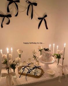 a table topped with a cake and lots of candles