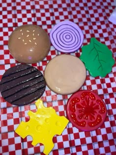 an assortment of cookies and pastries on a checkered tablecloth