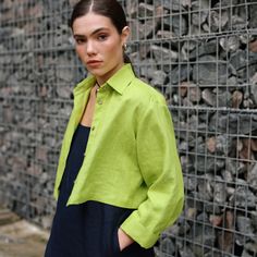 "Our Cropped Linen Shirt is a modern version of a button-up women's shirt. It features a relaxed fit with a back pleat and cuffed bracelet-length sleeves. The slightly cropped design is perfect for playing with proportions. Pair it with high-waisted skirts for casual days or try it with a flowing midi skirt to dress it up.  DETAILS ⚬ Pointed collar. ⚬ Front button closure. ⚬ Drop shoulders. ⚬ Cuffed bracelet-length sleeves. ⚬ Cropped length. ⚬ Made of organic Oeko-Tex-certified linen. ⚬ The linen is NOT see-through. ⚬ Shown here in Chartreuse Green. FIT / SIZE ⚬ Designed for a loose fit. ⚬ The front length (from the shoulder to the hem) is  ± 19\" (50 cm).  If you would like to add or subtract 10cm from the length, just let us know. ⚬ Sizes XXS to 7XL (please see detailed size chart in pho Spring Cropped Blouse With Button Cuffs, Casual Cropped Blouse With Button Cuffs, Spring Cropped Button-up Shirt With Pockets, Spring Tops With Button Cuffs And Casual Collar, Relaxed Fit Blouse With Casual Collar For Work, Chic Collared Cropped Shirt For Spring, Spring Long Sleeve Cropped Shirt With Button Cuffs, Modern Button-up Top With Placket, Relaxed Fit Blouse With Casual Collar For Spring