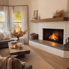 a living room filled with furniture and a fire place in the middle of the room