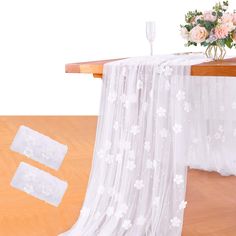 the table cloth is white with flowers on it