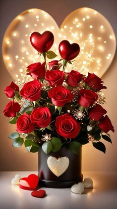 a vase filled with red roses and hearts