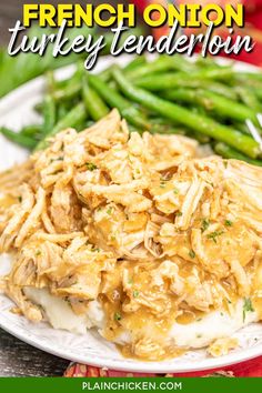 a white plate topped with chicken and green beans