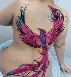 a woman with tattoos on her back and breast is shown in the image, it looks like