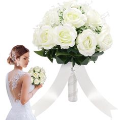 a woman in a wedding dress holding a bouquet of white roses and looking at it