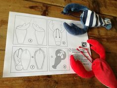 stuffed lobsters are laying on top of paper with instructions for how to sew them