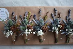 six bouquets of flowers are arranged on a piece of brown paper with twine