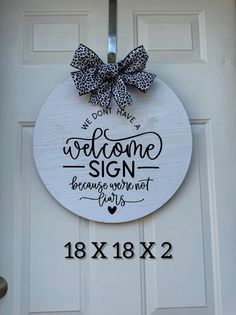 a welcome sign is hanging on the front door