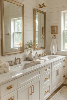 a bathroom with two sinks and mirrors in it