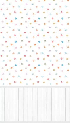 a white wall with multicolored dots on it