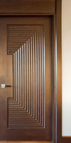 a wooden door with an abstract design on it