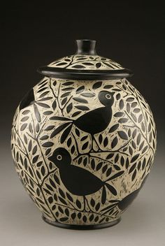 a black and white vase with two birds on it