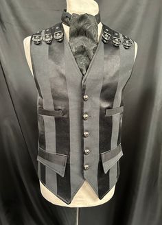 "This is a stunning black heavy suiting fabric waist coat.It is fully lined .It has wide stripes. It has 4 pockets and adjustable back and has buckles detail on front and back shoulder . It has gunmetal buttons. It comes with a black brocade cravat . Chest measurement is XL approx 44/46.  ML chest 40/42  Please refer to measurement in photos.  Length front approx 24\". Adjustable waist . High quality well made Makes a stunning steampunk gentleman's outfit! Thank you for looking" Black Gothic Vest For Alternative Fashion, Black Gothic Costume Vest, Gothic Black Vest For Costume, Black Vest For Halloween Costume, Gothic Black Vest For Costume Party, Steampunk Style Sleeveless Black Vest, Black Sleeveless Steampunk Vest, Steampunk Black Sleeveless Vest, Black Steampunk Sleeveless Vest