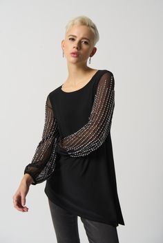 This luxurious tunic is crafted from a silky knit fabric, with mesh puff sleeves for a touch of drama. The asymmetrical design is flattering and feminine, while the beading detail adds a touch of glamour.  Color - Black. Silky knit with mesh. Beading on sleeves. Boat neckline. Puff sleeves. Asymmetrical hem. Unlined. Sheer Sleeves Top, Stylish Tunic, Feminine Blouses, Black Tunic, Joseph Ribkoff, Beaded Top, Knit Tunic, Tunic Styles, Asymmetrical Design