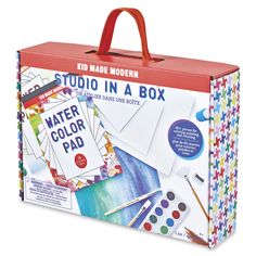 a box with watercolors and paper on the inside is open to show it's contents