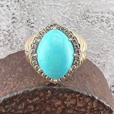 Lovely Turquoise surrounded by Champagne Diamonds set in a 14K Yellow Gold Ring. US Size 10 3/4 Measures approximately 22.4 mm at widest point Back of the shank tapers down to approximately 3.25 mm Stamped 14k Nicely weighted at 10.5 grams, approximately. Champagne Diamond, Halo Diamond, Yellow Gold Rings, Size 10, Rings Statement, Bones, Halo, Champagne, Statement Rings