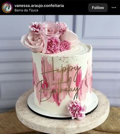 a birthday cake with pink flowers on top