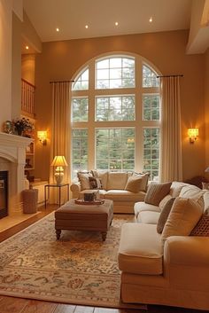 a living room filled with lots of furniture and a fire place in front of a large window