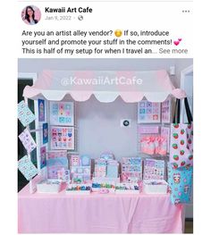 a pink table topped with lots of cards and boxes next to a white awning