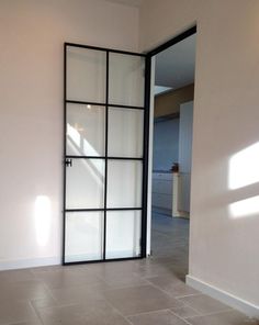 an empty room with a sliding glass door in the center and tile flooring on the other side