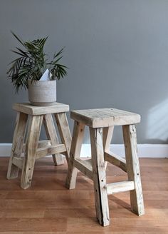 two wooden stools sitting on top of a hard wood floor