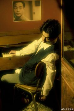 a man sitting in front of a piano