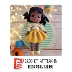 a crochet doll is wearing a yellow dress and brown boots with her hair in pigtails