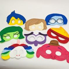 a group of felt masks sitting on top of a table