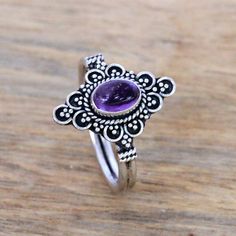 For a dreamy accessory to add to your wardrobe this cocktail ring is designed by Bali's Ketut Sulastri. She handcrafts the ring of sterling silver with an intricate crown that is centered by an oval cabochon of gleaming purple amethyst. Spiritual Sterling Silver Amethyst Ring, Bohemian Amethyst Crystal Ring In Silver, Bohemian Sterling Silver Amethyst Ring With 925 Stamp, Bohemian Sterling Silver Amethyst Ring, Bohemian Silver Amethyst Ring, Handmade Bohemian Amethyst Ring In Sterling Silver, Bohemian Sterling Silver Filigree Ring, Bohemian Amethyst Ring As Gift, Bohemian Amethyst Ring