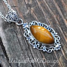 Handmade, Natural Tigers Eye Sterling Silver pendant on a 18" Sterling Silver Chain. ❤︎Featured in this listing is a sterling silver, handmade, natural stone pendant.  This lovely handmade pendant features a beautiful, Natural Tiger's Eye marquise shaped stone.  ❤︎The lovely marquise stone has been bezel set into a highly polished, victorian style embellished Sterling Silver setting, with with a large detailed bail.   ❤︎All made with Sterling Silver and comes featured on an 18" Chain  Main Stone Elegant Brown Sterling Silver Necklace, Sterling Silver Brown Necklace For Gift, Brown Hallmarked Sterling Silver Jewelry, Elegant Brown Jewelry Stamped 925, Elegant Brown Stamped 925 Jewelry, Elegant Brown 925 Sterling Silver Jewelry, Handmade Brown Sterling Silver Necklace, Artisan Brown Sterling Silver Necklace, Brown Engraved Jewelry For Anniversary