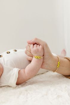 These sunny yellow smiley face beads surrounded by gold filled beads are a positive and darling accessory to highlight your child’s tiny wrist. The perfect accessory for every Mom + her mini! Made with the highest quality materials, this bracelet will look beautiful for years to come. Durable enough for play, precious enough to keep forever. Materials: 14k gold filled or sterling silver components. Nickel free. To learn more about our materials and what makes gold filled unique read here. Features: Each bracelet has a ½” extender chain to allow it to grow with your child. Guarantee: 100% satisfaction guaranteed. If you don’t love it, contact us to arrange a return/exchange. Read more about our quality guarantee here. PLEASE WATCH TEETHING BABIES CAREFULLY AS SMALL COMPONENTS CAN POSE AS A Cute Handmade Gold Beaded Bracelets, Playful Gold Beaded Bracelets For Everyday, Adjustable Smiley Face Round Bead Jewelry, Cute Gold Beaded Bracelets For Mother's Day, Cute Yellow Jewelry With Letter Beads, Personalized Fun Gold Bracelets, Playful Yellow Jewelry With Letter Beads, Playful Gold Jewelry With Smiley Face, Playful Handmade Gold Jewelry