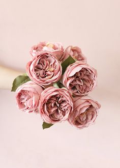 a bouquet of pink flowers sitting on top of a table