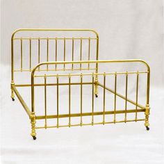 two golden metal beds with wheels on each side and no headboard or foot board