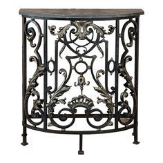 an ornate iron table with marble top