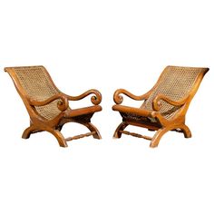 a pair of wooden chairs sitting next to each other on top of a white background