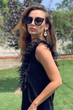 The season-less black top you can wear forever. Lovely Black crepe fabric with real sustainable sourced ostrich feathers. Keyhole back neckline. Women Fashion, Easter outfits ideas, Spring fashion, Spring style, Casual outfits, Style inspiration, Women's top, Women fashion top. #womenfashion #easterfashion #springfashion #springoutfits #styleideas #womentop #evafranco Chic Sleeveless Feathered Top, Elegant Feathered Evening Tops, Chic Evening Top With Feathers, Elegant Party Tops With Feather Trim, Elegant Party Top With Feather Trim, Glamorous Feather Trim Top For Night Out, Spring Evening Tops With Feather Trim, Chic Black Top With Feather Trim, Black Feathered Party Top