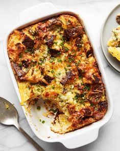 a casserole dish with meat and cheese in it next to a plate of food