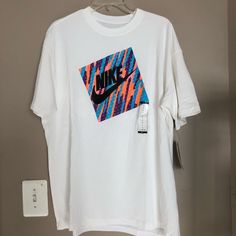 New With Tag! White Graphic Design Top For Summer, White Summer Top With Graphic Design, White Graphic Design Tops For Summer, White Logo Print T-shirt For Summer, White Graphic Design Shirt For Summer, Nike Relaxed Fit Shirt For Spring, White Sporty Shirt For Summer, Nike Cotton Shirt For Summer, Nike Cotton Summer Shirt