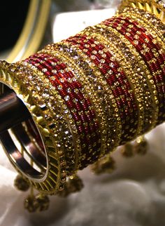 Yala - Maroon & Gold Chuda Bangles for Brides with Stone & Dangles Traditional Punjabi Chooda bangles do not just carry stories of cultural value. But, also adds a touch of elegance to the bride's outfit. Gold & Maroon Chooda bangle accessory comes with stone embellishments. Luxurious crystals on this Indian Chooda make it unique bangle jewelry. Multiple embellishments of glam adorn this Chuda bangle, making it the perfect piece for your Indian bridal ceremony. Glamourous gold dangli Maroon Chooda Designs Brides, Maroon Chooda, Bangle Making, Unique Bangle, Maroon Wedding, Punjabi Bride, Desi Bride, Bangle Jewelry, Desi Wedding